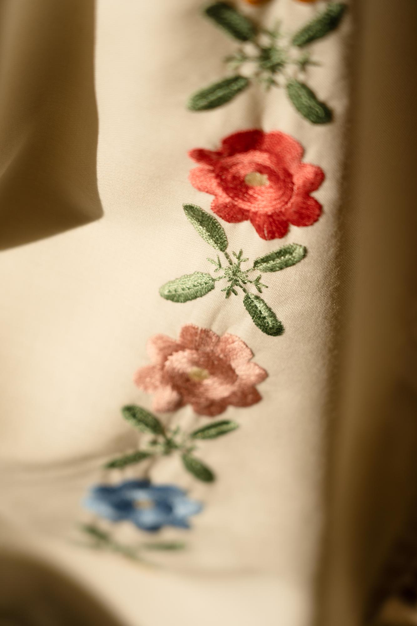 Close-up of floral hand embroidery on linen